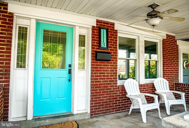 view of exterior entry featuring ceiling fan