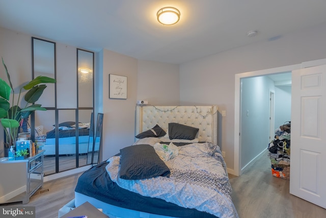 bedroom with light wood-type flooring