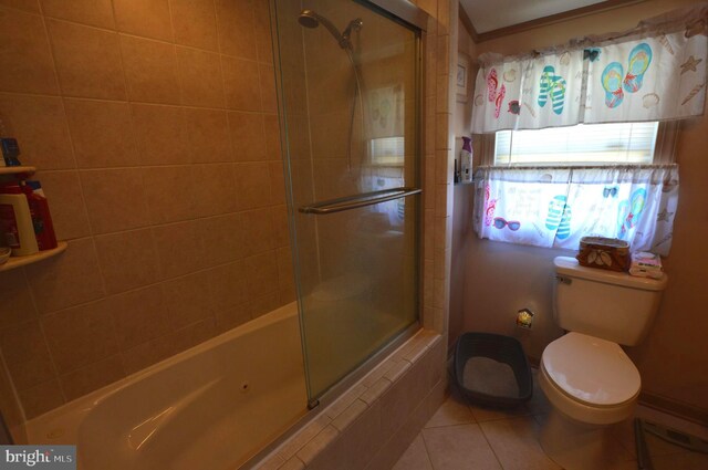 bathroom featuring separate shower and tub, toilet, and tile patterned flooring