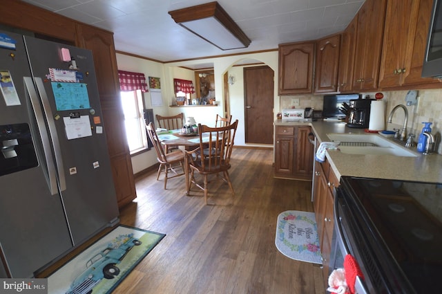 kitchen featuring tasteful backsplash, stainless steel appliances, sink, and dark hardwood / wood-style floors