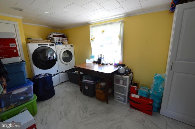 laundry room with washer and dryer and ornamental molding