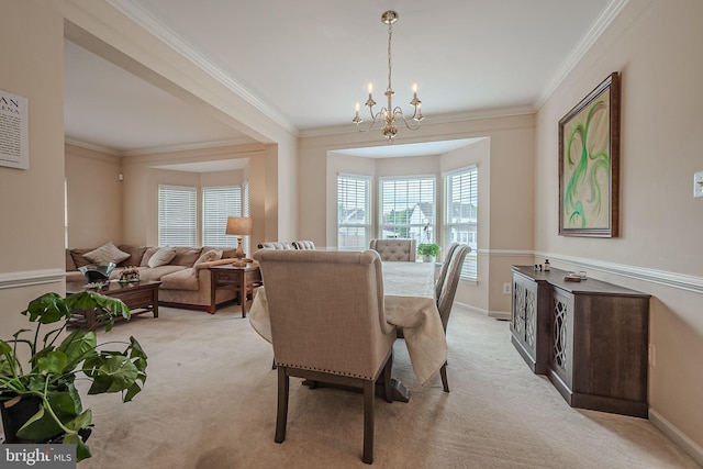 dining space with ornamental molding, an inviting chandelier, and light carpet