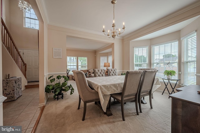 dining room with ornamental molding, light tile patterned floors, and a notable chandelier