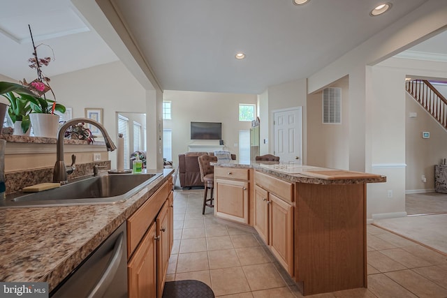 kitchen featuring dishwasher, plenty of natural light, sink, and a kitchen island