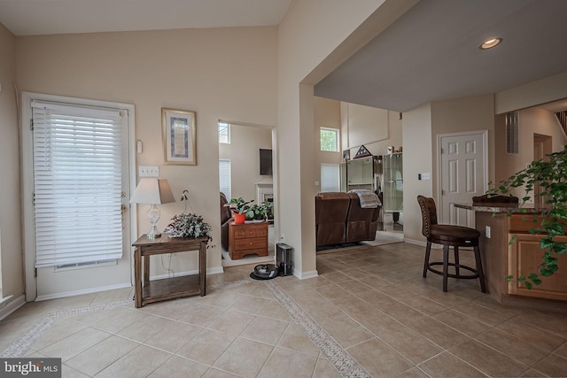 tiled entryway with high vaulted ceiling