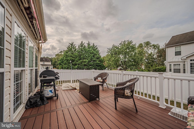 deck featuring grilling area and a fire pit