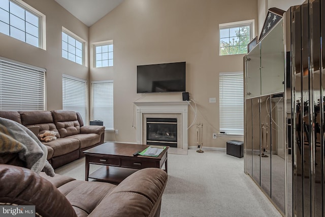 living room with light carpet and high vaulted ceiling