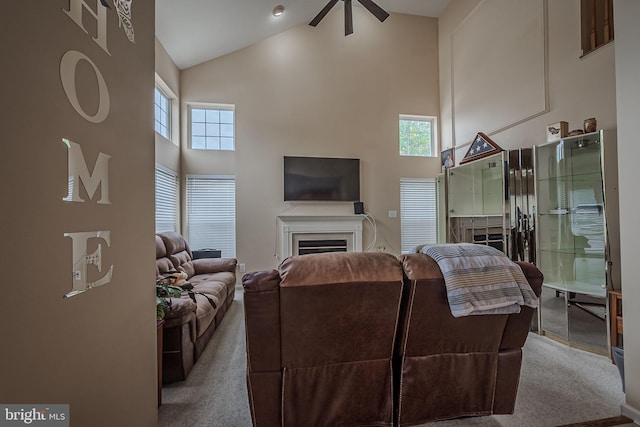 carpeted living room featuring beam ceiling, ceiling fan, and high vaulted ceiling