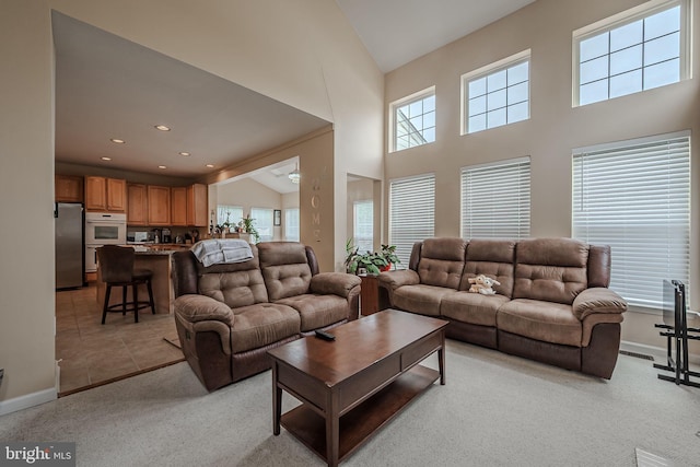 living room with lofted ceiling and light colored carpet