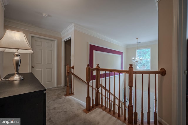 hallway featuring light colored carpet, an inviting chandelier, and crown molding