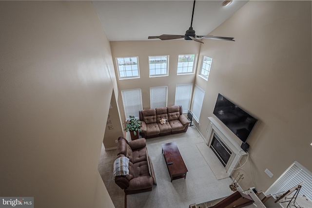 living room featuring high vaulted ceiling and ceiling fan