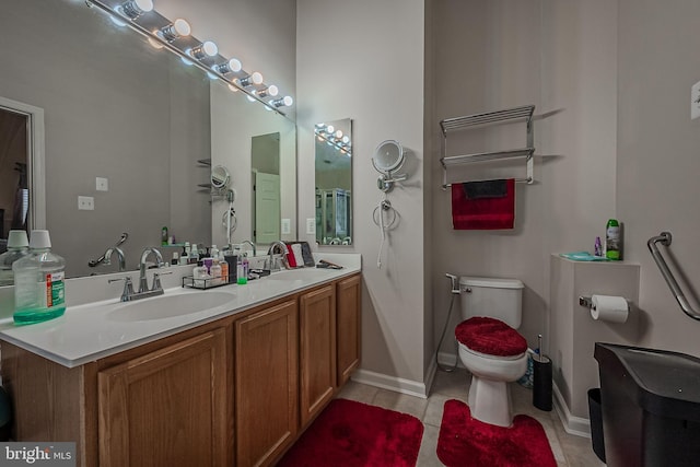 bathroom featuring tile patterned floors, vanity, and toilet