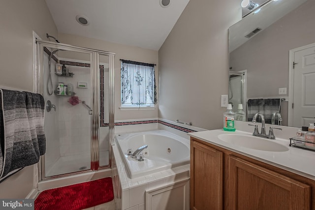 bathroom with vanity, lofted ceiling, and shower with separate bathtub