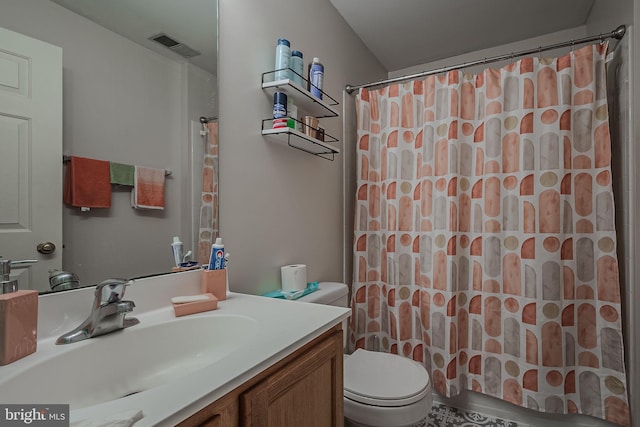 bathroom featuring vanity, toilet, and a shower with shower curtain