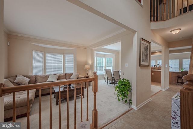 living room featuring ornamental molding and light tile patterned floors