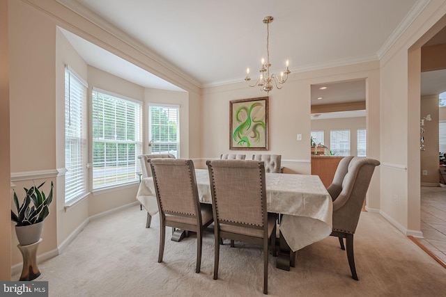 carpeted dining room featuring ornamental molding and a chandelier