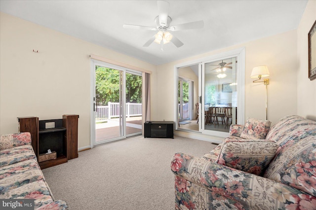 carpeted living room with ceiling fan