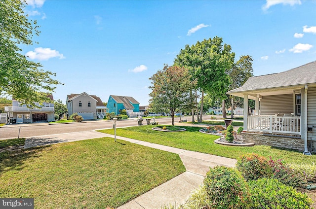 view of yard with a porch and a garage