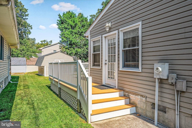 doorway to property with a yard