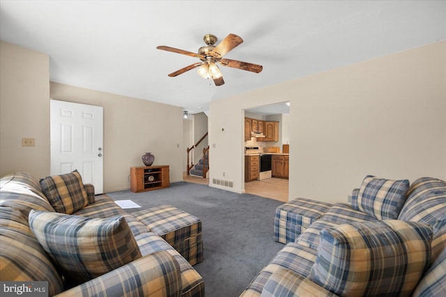 carpeted living room with ceiling fan