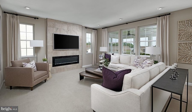 carpeted living area featuring recessed lighting, baseboards, and a tile fireplace