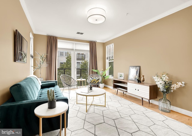 sitting room with light wood-type flooring and ornamental molding