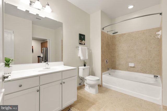 full bathroom featuring tiled shower / bath combo, vanity, toilet, and tile patterned floors