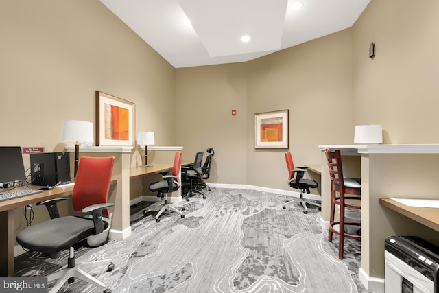 carpeted office space featuring lofted ceiling