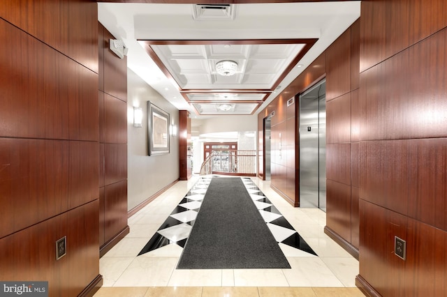 hallway featuring light tile patterned floors and elevator