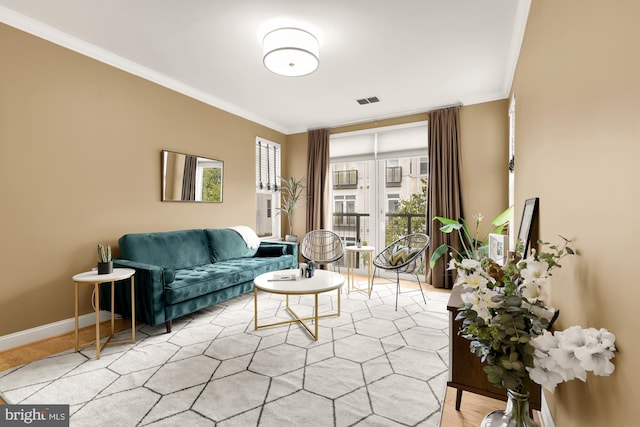 living room with light hardwood / wood-style flooring and ornamental molding