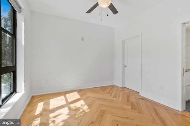 unfurnished room with light parquet floors and ceiling fan