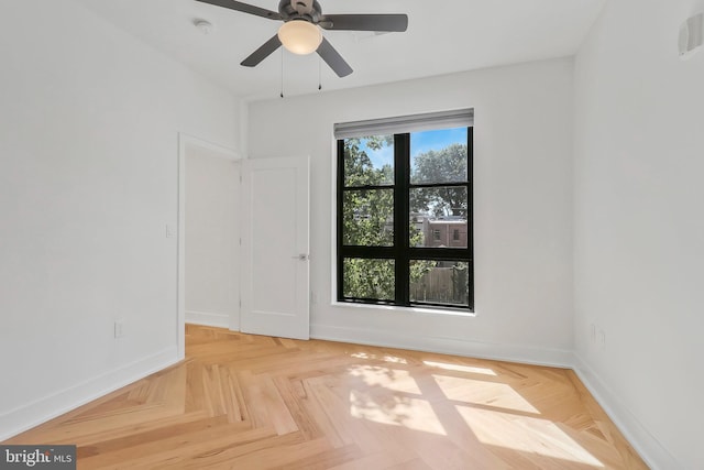 unfurnished room featuring light parquet flooring and ceiling fan