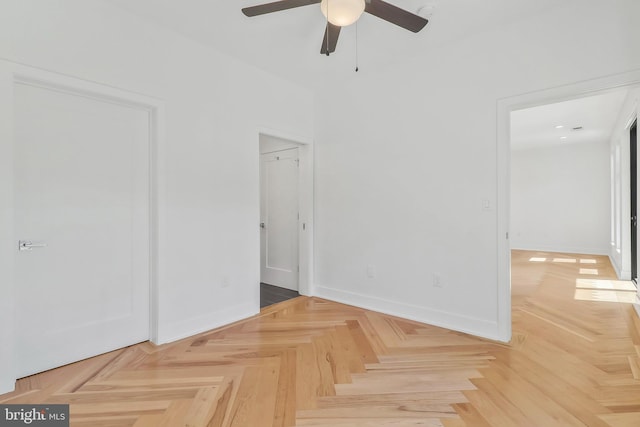 spare room featuring parquet floors and ceiling fan