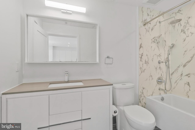 full bathroom featuring tiled shower / bath, vanity, and toilet