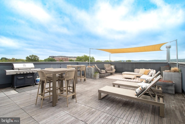 deck with a grill and an outdoor hangout area