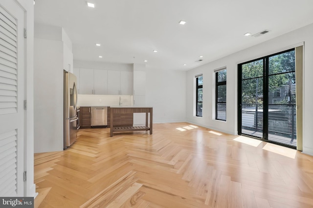 interior space featuring light parquet floors and sink