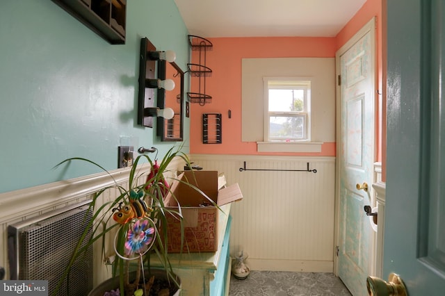 bathroom with a wainscoted wall