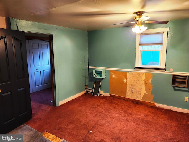 unfurnished room with carpet flooring, a ceiling fan, and baseboards