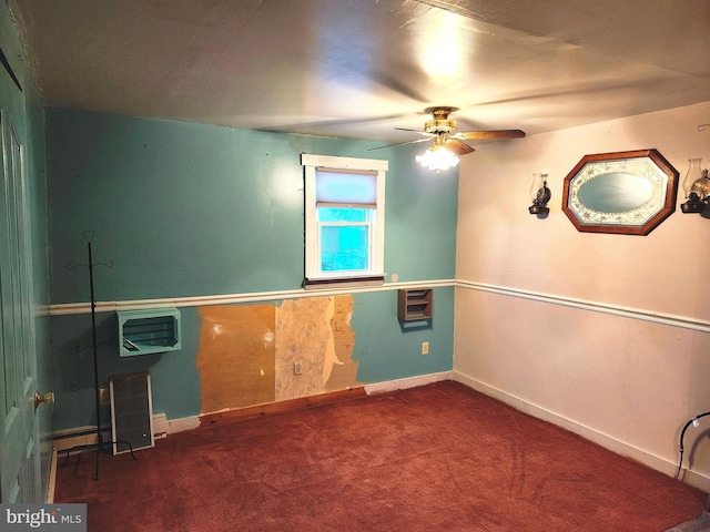 carpeted spare room with baseboards and a ceiling fan