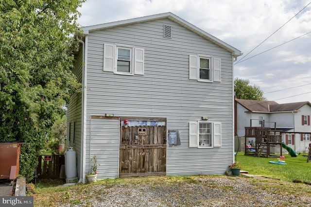 rear view of property featuring a yard