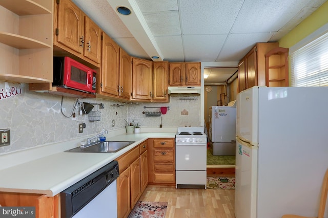 kitchen with a sink, white appliances, open shelves, and under cabinet range hood