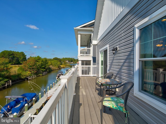 wooden terrace featuring a water view