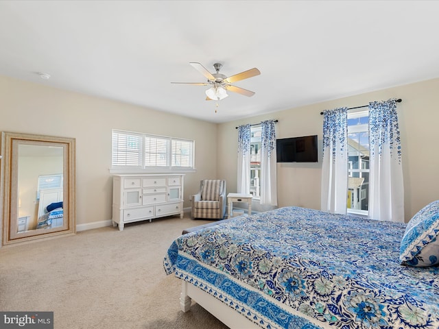 bedroom with ceiling fan and light colored carpet