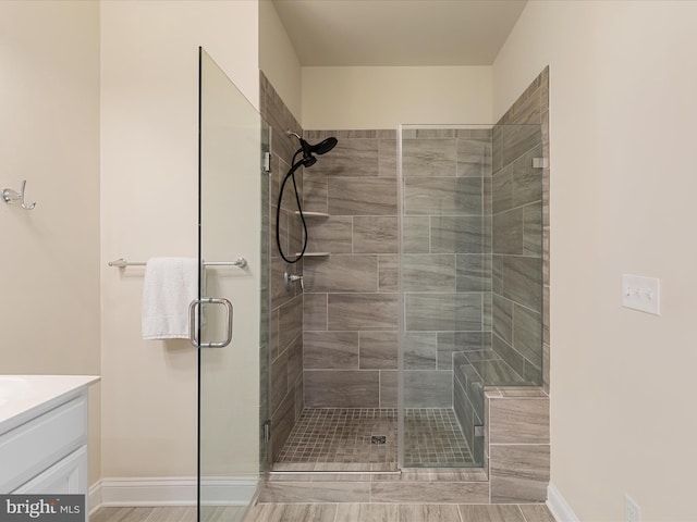 bathroom featuring vanity, hardwood / wood-style flooring, and an enclosed shower