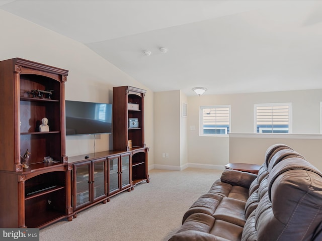 carpeted living room featuring vaulted ceiling