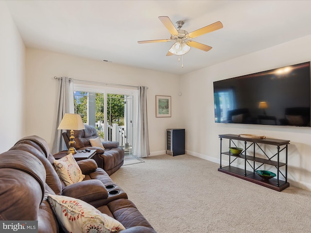 carpeted living room featuring ceiling fan