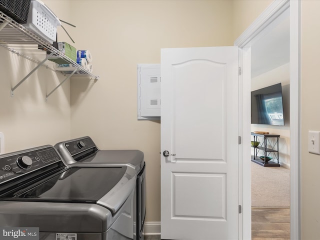 washroom with independent washer and dryer and hardwood / wood-style flooring