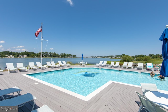 view of pool featuring a deck with water view