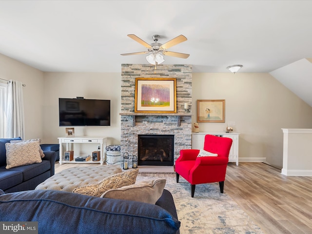 living room with a fireplace, wood-type flooring, ceiling fan, and lofted ceiling