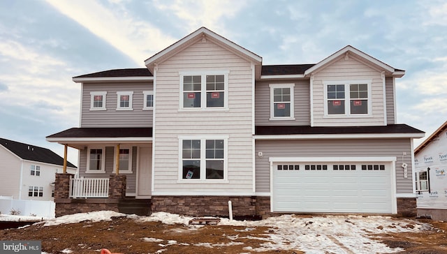 view of front facade featuring covered porch and a garage